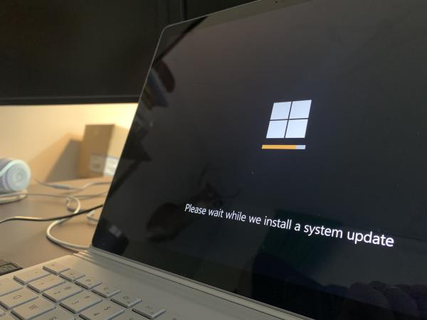 Black and white photo of a laptop showing a software update screen. Photo by Clint Patterson (@cbpsc1) on Unsplash.